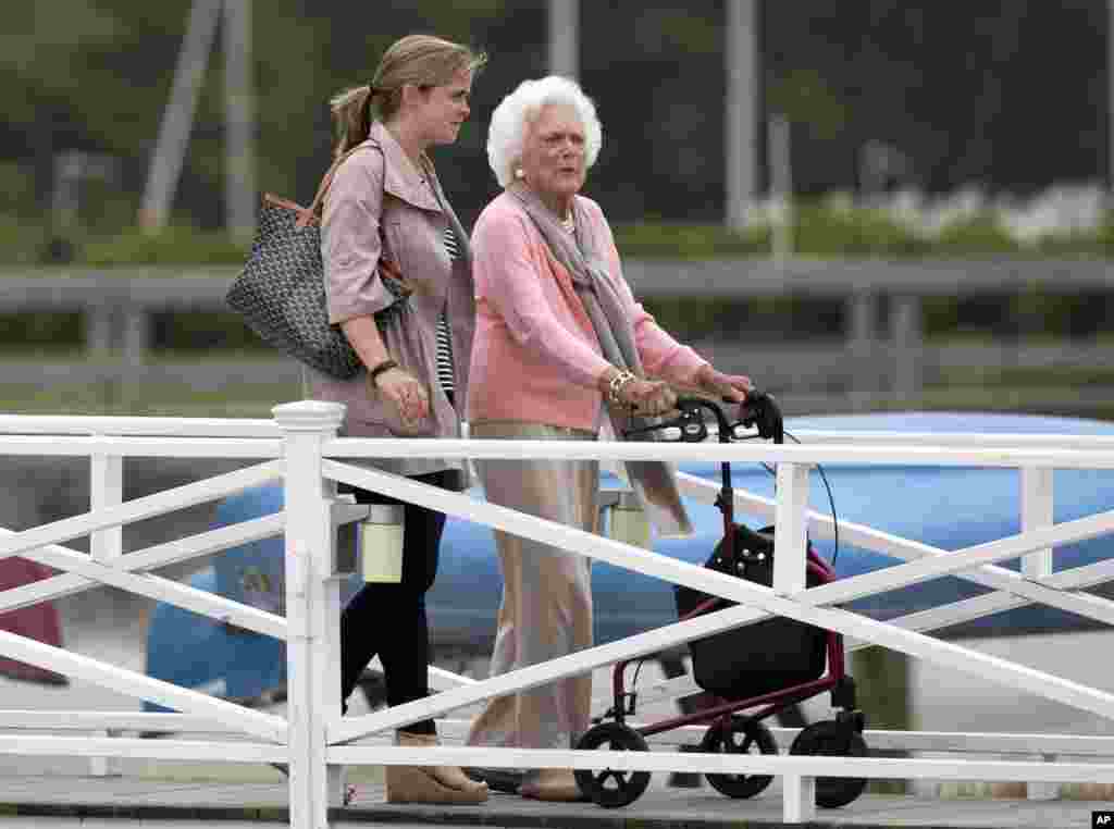 Former first lady Barbara Bush uses a walker as she leaves a luncheon at the Kennebunk River Club on her 90th birthday, June 8, 2015, in Kennebunkport, Maine. 