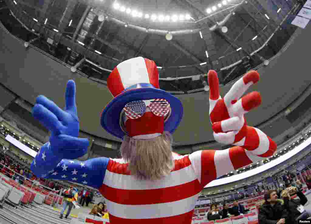 A fan of the U.S. dressed in a costume in the colors of the national flag gestures ahead of the women's ice hockey gold medal game against Canada at the Sochi 2014 Winter Olympic Games in Russia.