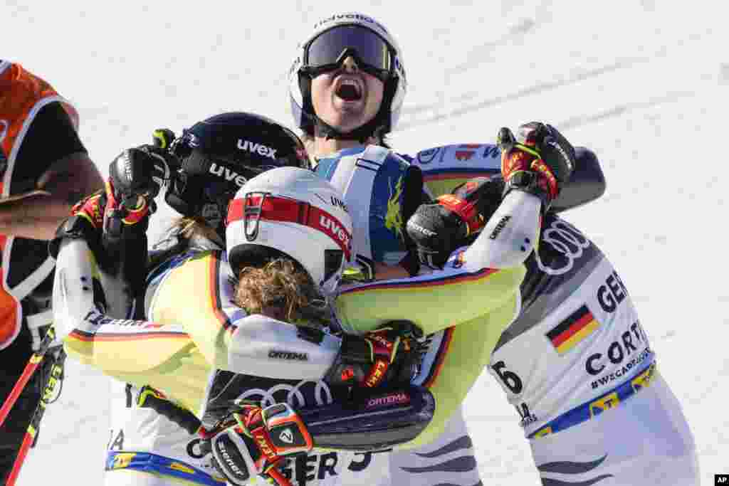 Germany team celebrates winning bronze medal in the mixed team parallel slalom, at the Alpine Ski World Championships in Cortina d&#39;Ampezzo, Italy.
