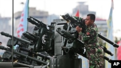 FILE - An Indonesian soldier cleans up a missile launcher during a military exhibition in Jakarta.