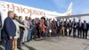 Ethiopian Airlines employees pose for a group photo in front of a Boing 737 MAX on the tarmac of the Bole International Airport in Addis Ababa, Feb. 1, 2022. 