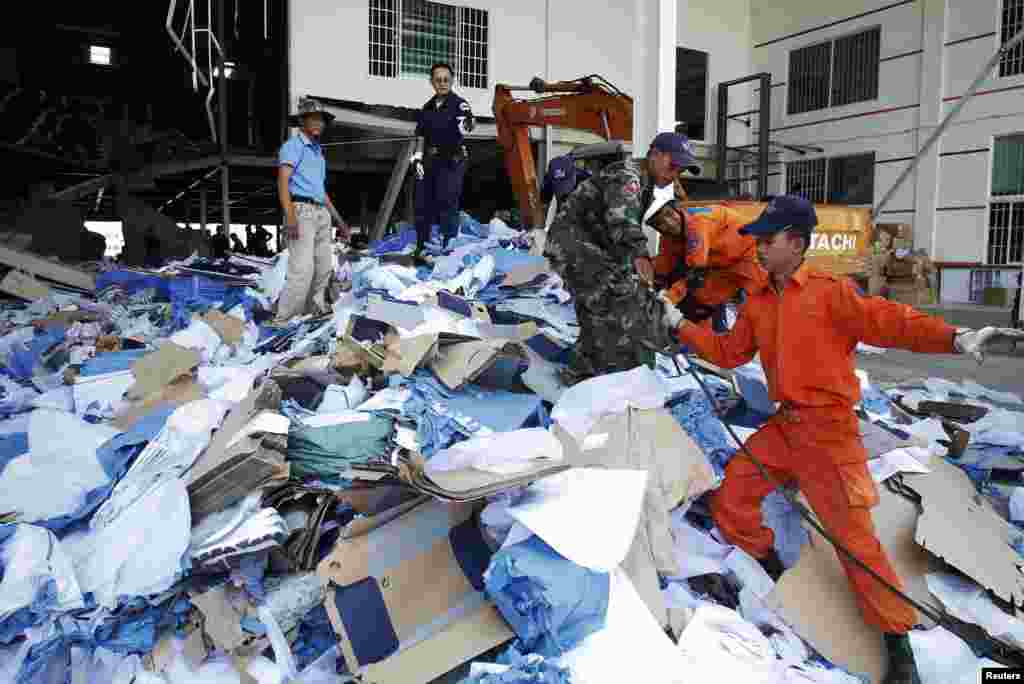 Rescue workers and soldiers search through a site of the accident in a shoe factory in Phnom Penh, May 16, 2013.