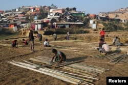 FILE - Rohingya refugees build shelter with bamboo at the Jamtoli camp in the morning in Cox's Bazar, Bangladesh, Jan. 22, 2018.