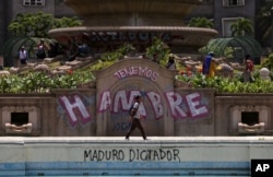 Anti-government protesters begin gathering at Altamira Plaza, defaced with messages that read in Spanish; "We're hungry. Maduro Dictator," in Caracas, Venezuela, June 26, 2017.