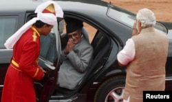 FILE - Nepal's Prime Minister Khadga Prasad Sharma Oli, center, greets his Indian counterpart, Narendra Modi, right, after his ceremonial reception at the forecourt of India's Rashtrapati Bhavan presidential palace in New Delhi, India, Feb. 20, 2016.