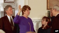 FILE - Supreme Court Justice Byron White, right, administers the oath of office to Janet Reno making her Attorney General during a ceremony at the White House, March 12, 1993.