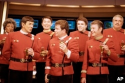 Members of the "Star Trek" crew, from right in front: DeForest Kelley, William Shatner and Leonard Nimoy, and back row from right: James Doohan, Walter Koenig, George Takei and Nichelle Nichols, toast "Star Trek V: The Final Frontier," during a news conference Dec. 28, 1988, at Paramount Studios.