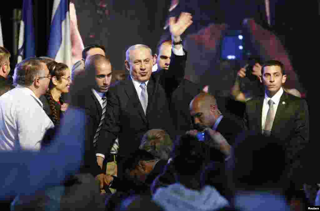 Israeli Prime Minister Benjamin Netanyahu waves to supporters at party headquarters in Tel Aviv, March 18, 2015.