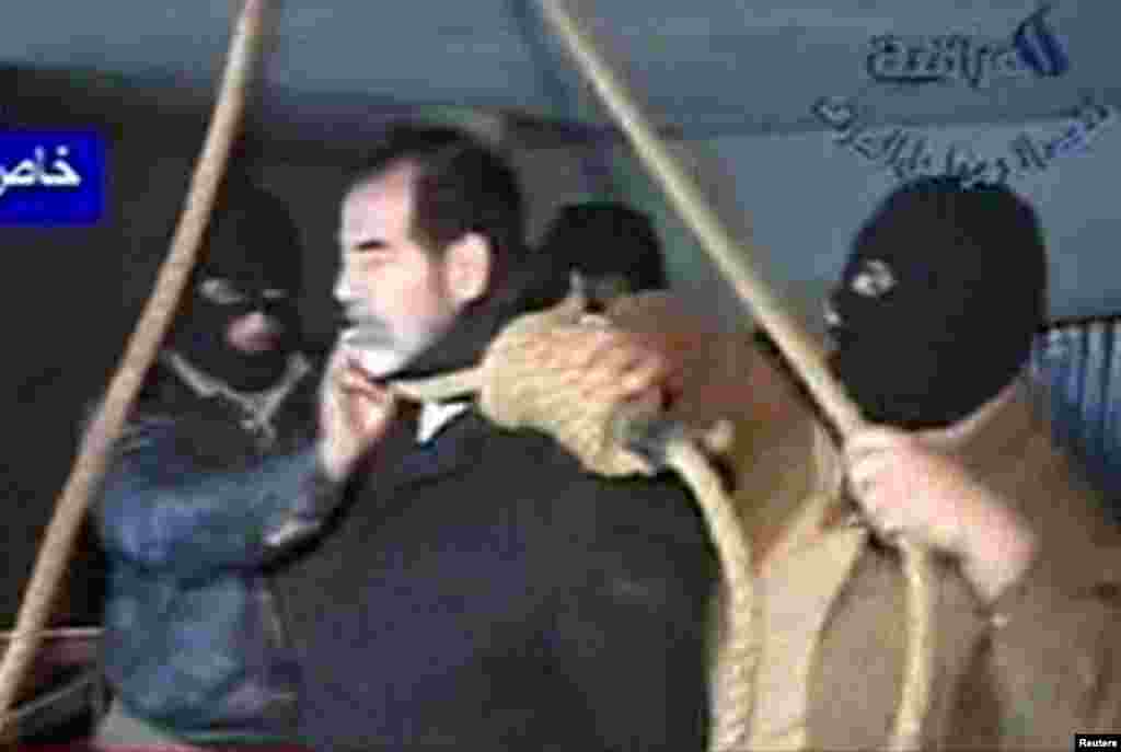 A still from Al Iraqiya television shows masked executioners putting a noose around former Iraqi President Saddam Hussein's neck moments before his hanging in Baghdad, Dec. 30, 2006.