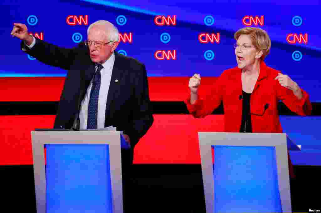 U.S. Senators Bernie Sanders (l) and Elizabeth Warren speak on the first night of the second 2020 Democratic presidential debate in Detroit, Michigan, July 30, 2019.