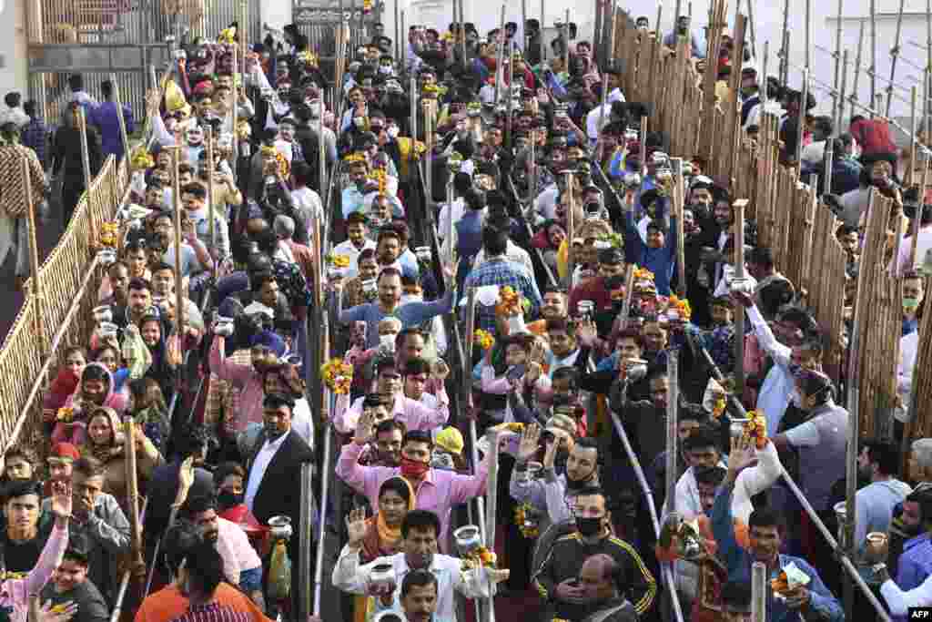 Hindu devotees queue to perform rituals to a Shiva Lingam, a stone sculpture representing the phallus of the Hindu deity Shiva, on the occasion of Maha Shivaratri festival at Shivala Bhaiyaan temple in Amritsar, India.