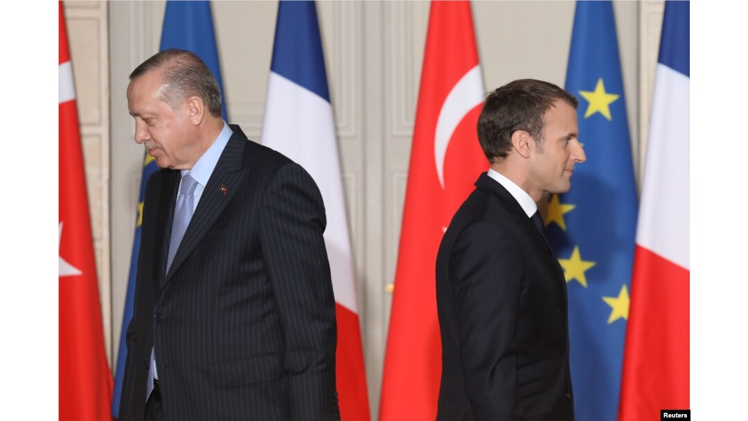 FILE - French President Emmanuel Macron (R) and his Turkish counterpart, Recep Tayyip Erdogan, walk past each other during a joint press conference at the Elysee Palace in Paris, France, Jan. 05, 2018.