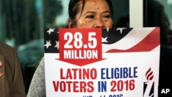 FILE - Georgina Arcienegas holds a sign in support of Latino voters in Florida, Jan. 12, 2016. The Clinton campaign has sharpened its focus on one of the most reliable strongholds it has in New York — the Latino vote. 