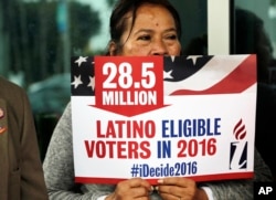 FILE - Georgina Arcienegas holds a sign in support of Latino voters in Florida, Jan. 12, 2016. The Clinton campaign has sharpened its focus on one of the most reliable strongholds it has in New York thus far — the Latino vote.