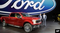 Ford Motor Co. Executive Chairman Bill Ford, left, and Chief Executive Mark Fields stand next to a Ford F-150 truck at the North American International Auto show, Jan. 9, 2017, in Detroit. 