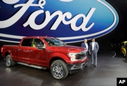 Ford Motor Co. Executive Chairman Bill Ford, left, and Chief Executive Mark Fields stand next to a Ford F-150 truck at the North American International Auto show, Jan. 9, 2017, in Detroit.