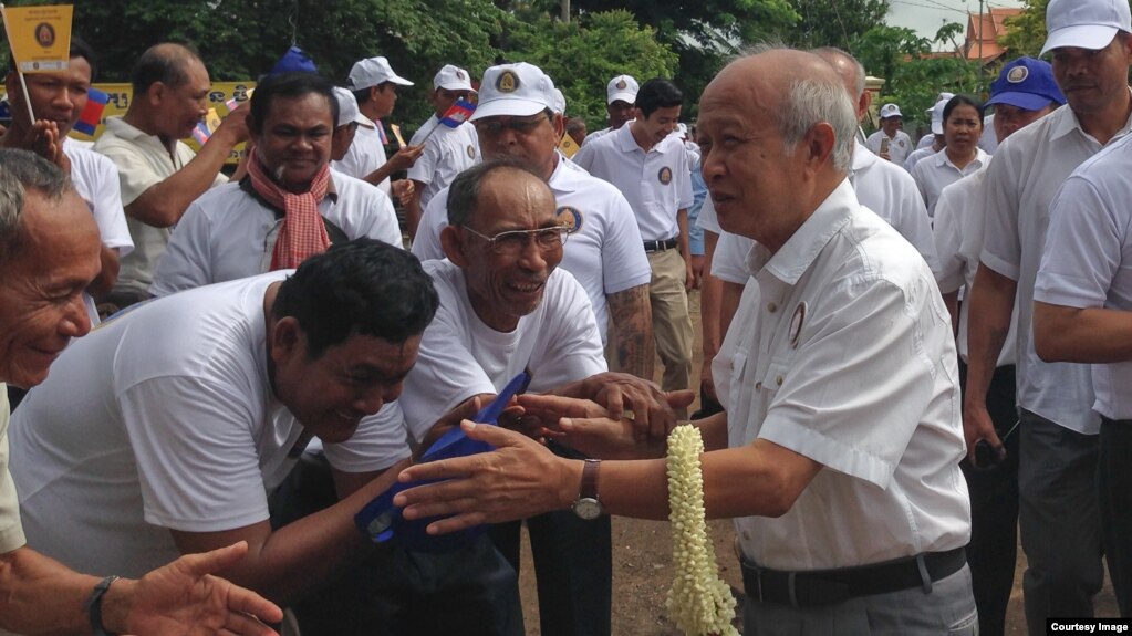 FILE: Prince Norodom Ranariddh, president of FUNCINPEC, is greeted by his supporters during an election campaign in Kampong Cham province on May 20, 2017. (Courtesy photo from a local journalist) 