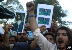 FILE - People rally to condemn the killing of Naqeebullah Mehsud, a 27-year-old aspiring model, in Karachi, Pakistan, Feb. 9, 2018.