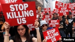 Protesters hold placards as they attend a demonstration demanding Hong Kong's leaders to step down and withdraw the extradition bill, in Hong Kong, June 16, 2019. 