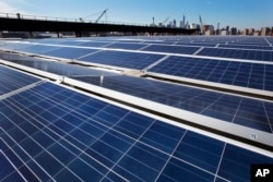 FILE - A rooftop is covered with solar panels at the Brooklyn Navy Yard in New York, Feb. 14, 2017.