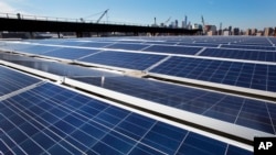 FILE - A rooftop is covered with solar panels at the Brooklyn Navy Yard in New York, Feb. 14, 2017.