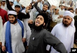 FILE - Pakistanis rally in support of Mumtaz Qadri who was convicted and executed for a blasphemy-motivated killing of a former governor, in Lahore, Pakistan, Feb. 29, 2016.