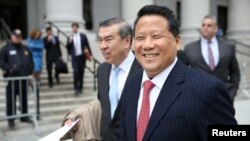 FILE - Macau billionaire real estate developer Ng Lap Seng, right, accused of bribing former United Nations General Assembly president John Ashe, exits the Manhattan U.S. District Courthouse in New York, April 7, 2017. 