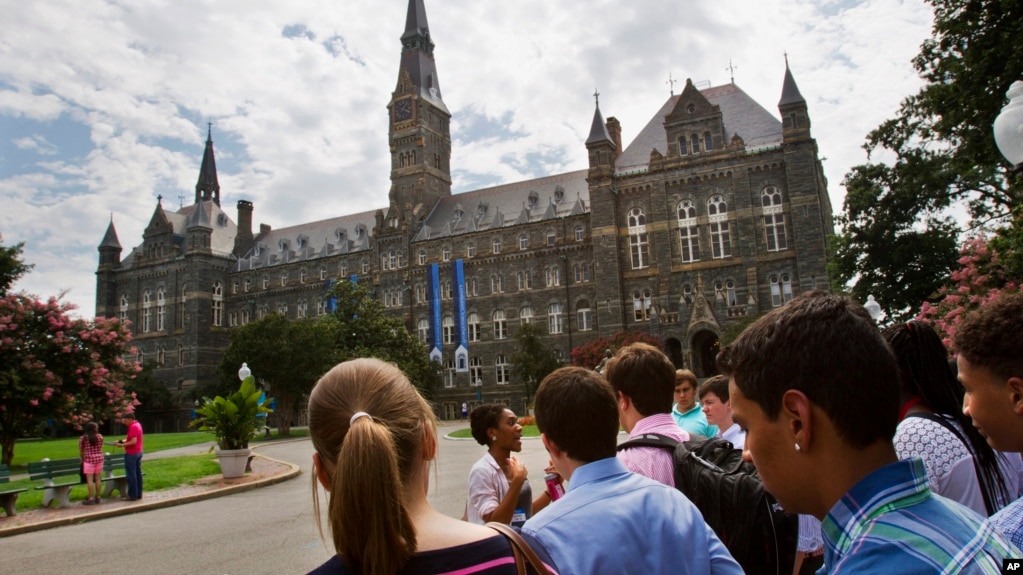 FILE - In this July 10, 2013, file photo, prospective students tour Georgetown University's campus in Washington., DC. (AP Photo/Jacquelyn Martin, File)
