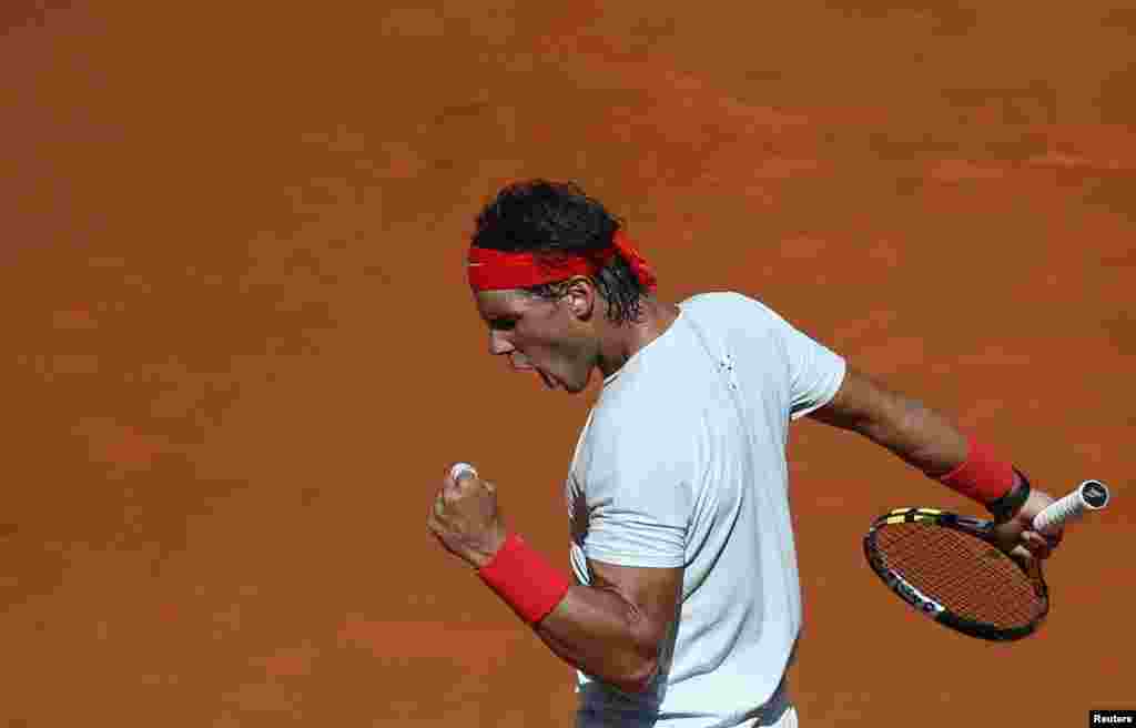Rafael Nadal of Spain celebrates winning a point against Mikhail Youzhny of Russia during their men&#39;s singles match at the Madrid Open tennis tournament, Spain. 
