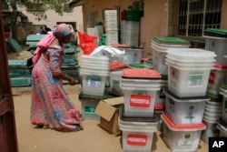 An electoral worker checks ballot boxes at the electoral commission office in Yola, Nigeria, Feb. 24, 2019.