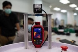 A temperature screening device is pictured as engineering professors program version two prototype of the IIUM Medibot medical robot, being developed for health workers to treat patients without risking infection from the COVID-19 coronavirus