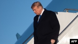 US President Donald Trump disembarks from Air Force One upon arrival at Joint Base Elmendorf-Richardson in Anchorage, Alaska, Feb. 28, 2019.