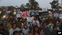 Indians participate in a candle light procession in protest against the rape and murder of 8-year-old Asifa Mohammad Yusuf Pujwala in Hyderabad, India, Friday, April 13, 2018.