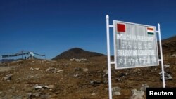 FILE - A signboard is seen from the Indian side of the Indo-China border at Bumla, in the northeastern Indian state of Arunachal Pradesh, November 11, 2009. 