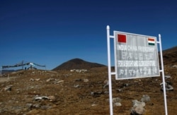 FILE - A signboard is seen from the Indian side of the Indo-China border at Bumla, in the northeastern Indian state of Arunachal Pradesh, November 11, 2009.