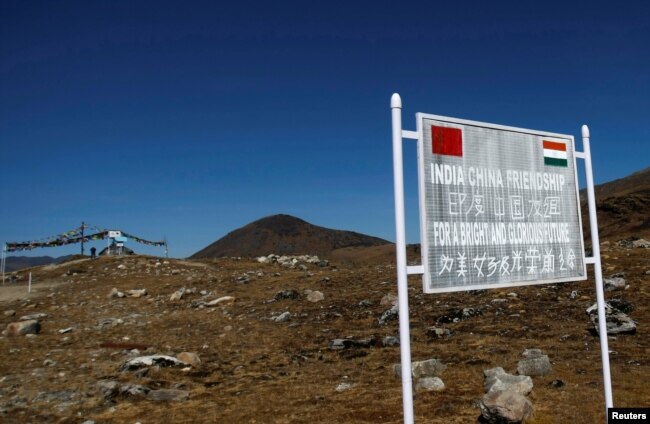 FILE - A signboard is seen from the Indian side of the Indo-China border at Bumla, in the northeastern Indian state of Arunachal Pradesh, November 11, 2009.