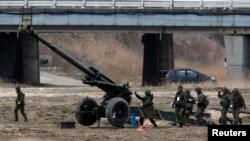 South Korean soldiers of an artillery unit take part in an artillery drill with 155mm Towed Howitzers as part of the annual joint military exercise "Foal Eagle" by the U.S. and South Korea, near the demilitarized zone (DMZ). 