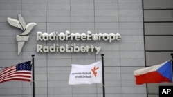 The headquarters of Radio Free Europe/Radio Liberty (RFE/RL) is seen with the United States, RFE/RL and the Czech Republic flags in the foreground, in Prague, January 15, 2010.