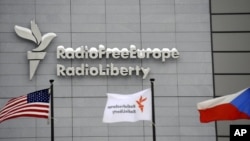 The headquarters of Radio Free Europe/Radio Liberty (RFE/RL) is seen with the United States, RFE/RL and the Czech Republic flags in the foreground, in Prague, January 15, 2010.