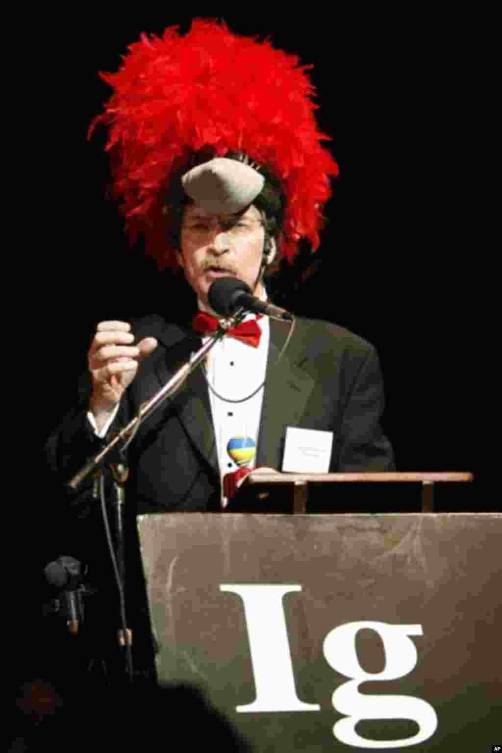 Ivan Schwab accepts the 2006 Ig Nobel prize in Ornithology at the 2006 Ig Nobel Awards ceremony at Harvard University in Cambridge, Massachusetts, October 5, 2006, for exploring and explaining why woodpeckers do not get headaches. The Ig Nobel Prizes are 
