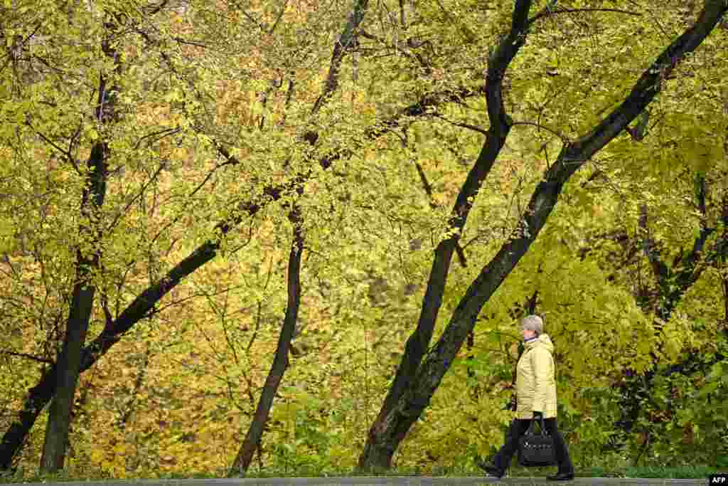 A woman walks on a street on an autumn day in Moscow, Russia, Oct. 2, 2021.