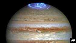 This composite image provided by NASA on June 30, 2016, shows auroras on the planet Jupiter. This image produced by NASA using a photograph captured by the Hubble Space Telescope in spring 2014, and ultraviolet observations of the auroras in 2016. On April 11, 2017, scientists reported a "Great Cold Spot" in the thermosphere of the planet. And unlike the giant planet’s familiar Great Red Spot, this newly discovered weather system is continually changing in shape and size. It's formed by the energy from Jupiter's polar auroras. 