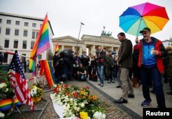 Vigil for victims of Pulse Orlando shooting in front of the U.S. Embassy and Brandenburg gate, Berlin, Germany, June 13, 2016.