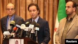 File - Khaled Khoja (center), the head of the Syrian National Coalition, speaks during a press conference as the former Secretary General Nasr Hariri, right, and the former president Hadi Bahra, left, stand next to him, in Istanbul, Turkey, January 2015.