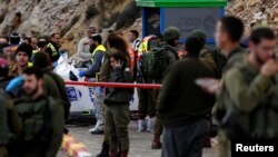 Israeli forces and medics are seen at the scene of a shooting attack near Ramallah in the Israeli-occupied West Bank December 13, 2018.