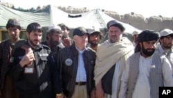 Secretary Gates poses for a photo with village elders in Tabin, March 8, 2011