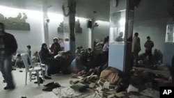 Residents rest in a shelter in is Baba Amr near Homs, February 8, 2012. Syrian forces thrusting into the rebellious city of Homs, killing dozens of civilians.