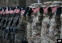 FILE - U.S. troops arrive at the Zagan base in western Poland as part of a deterrence force of some to be based there, Jan. 12, 2017.