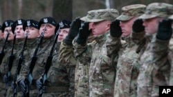 FILE - The first U.S. troops arrive at the Zagan base in western Poland as part of deterrence force of some 1,000 troops to be based there, Jan. 12, 2017