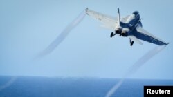 FILE - A Super Hornet takes off from the flight deck of the U.S. Navy aircraft carrier USS Nimitz, Oct. 29, 2016. A Super Hornet reportedly downed a Syrian SU-22 fighter jet Sunday.